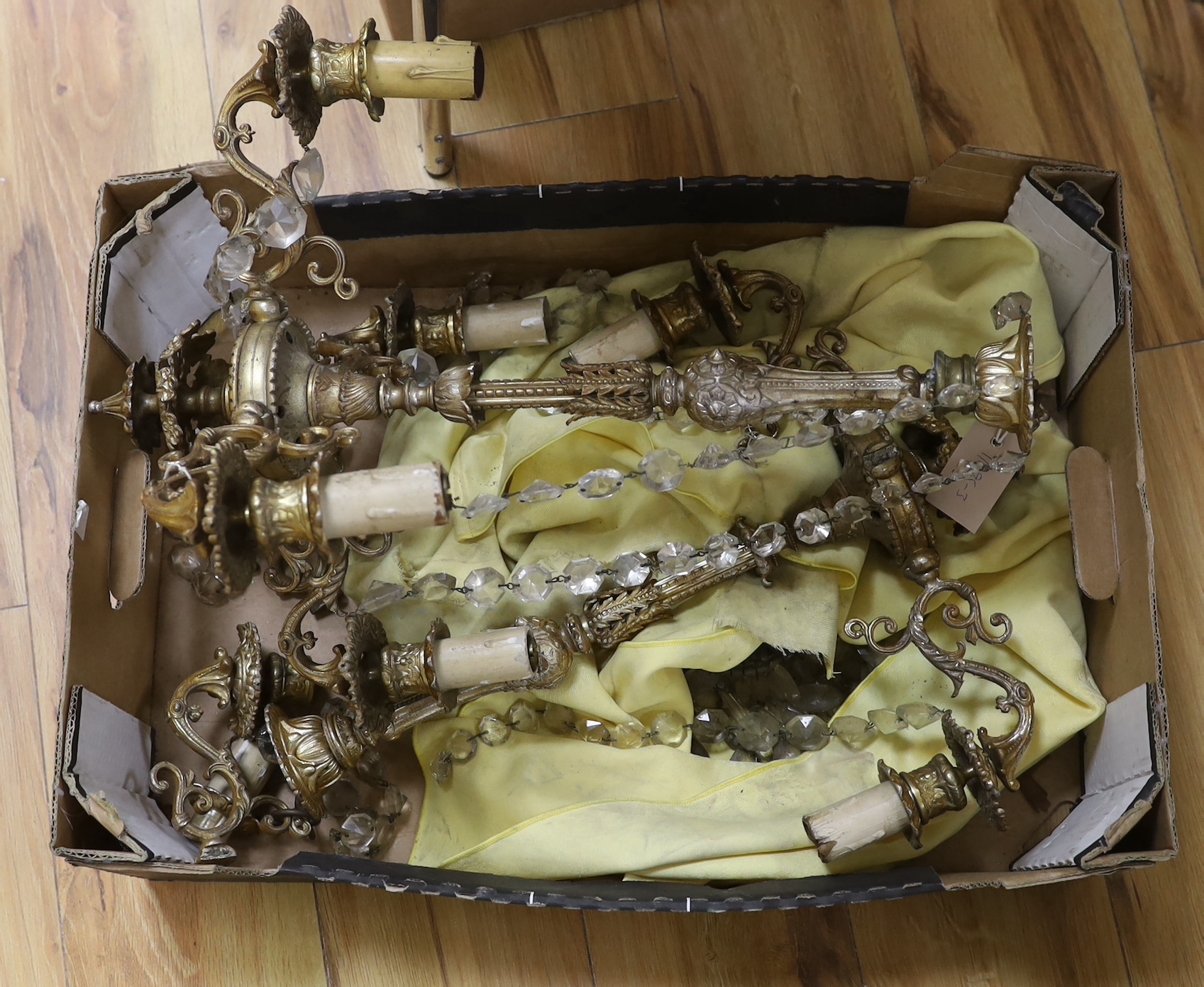 Two gilt metal four-branch chandeliers, with some crystal drops, the largest 52cm high